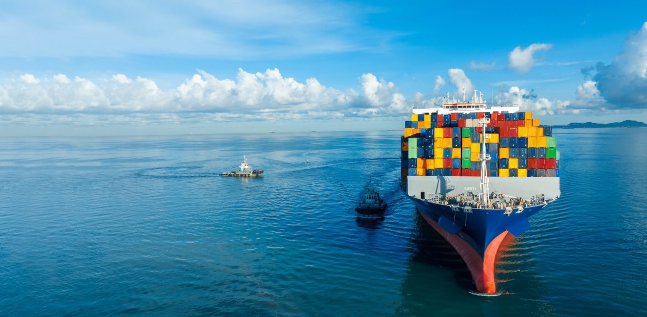 front-view-contaier-cargo-ship-import-export-container-box-on-the-ocean-sea-on-blue-sky (1)